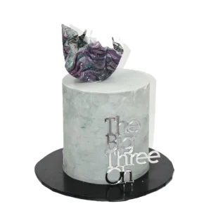 Modern 30th birthday cake with smooth grey-green frosting, abstract marbled topper, and silver “The Big Three Oh” decoration.