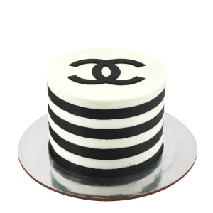 Black and white striped Chanel-inspired cake by Amarantos Cakes featuring alternating horizontal stripes, a smooth white top, and a black interlocking “C” logo.