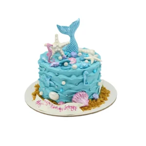 Mermaid-themed birthday cake with blue wave frosting, fondant mermaid tail, seashells, starfish, seahorses, pearls, and “Happy 25th Birthday Centayne” message.