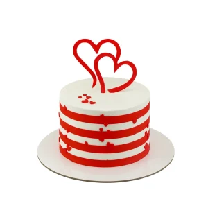 Romantic heart-themed cake by Amarantos Cakes featuring white fondant with horizontal red stripes, scattered red heart decorations, and two large upright heart toppers. Ideal for Valentine’s Day or anniversary celebrations.