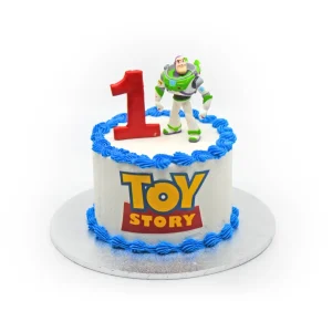 Toy Story birthday cake with white frosting, blue trim, Buzz Lightyear figurine, red number one topper, and logo.