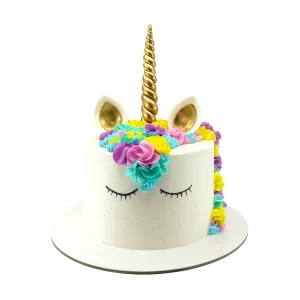 Unicorn-themed birthday cake with golden horn, closed eyes, and colorful fondant flower mane in vibrant shades