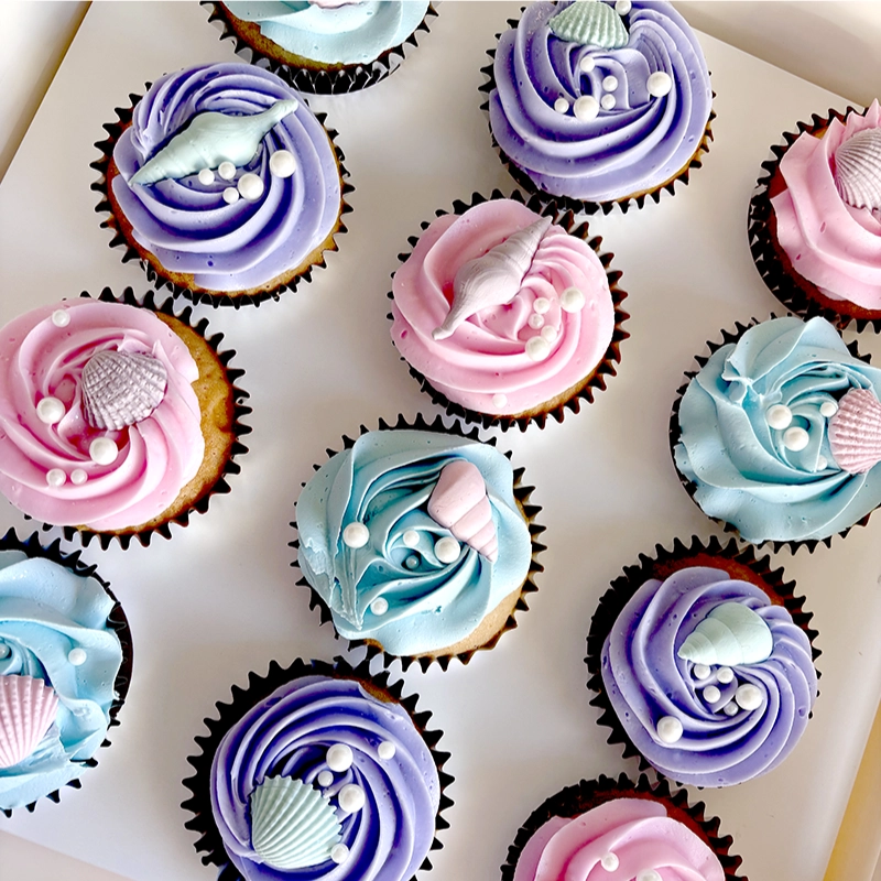 A pack of pink and purple cupcakes.
