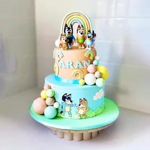 Bluey themed birthday cake sitting in cake stand.