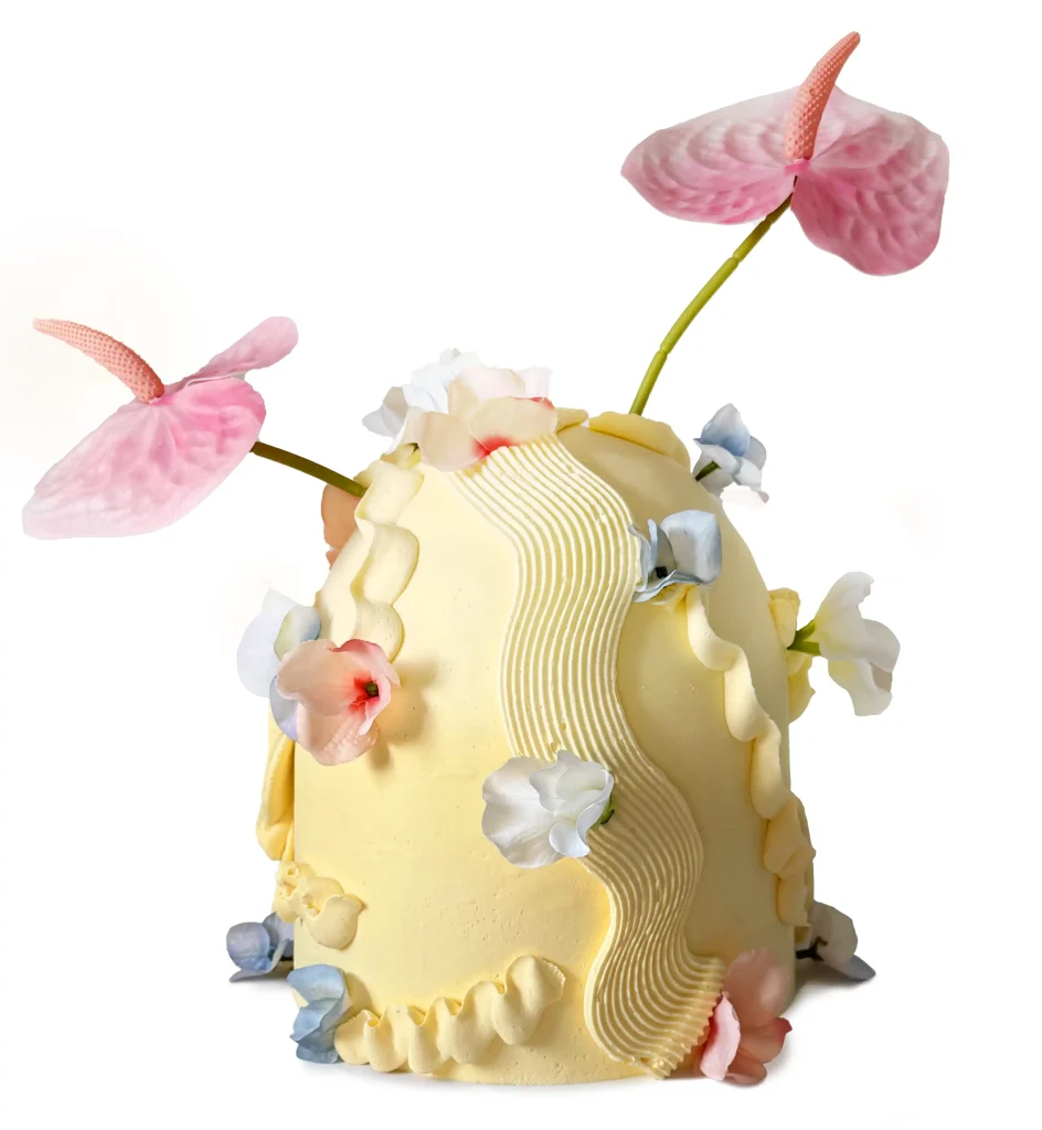 Fun little yellow cake with butterfly and flower decorations.