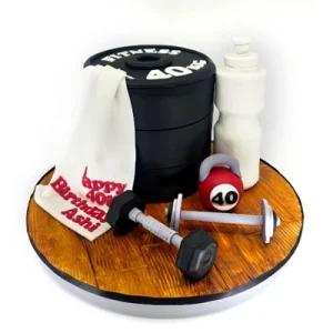 A gym themed birthday cake shaped into weights, a gym towel, dumbbells, and, a drink bottle.