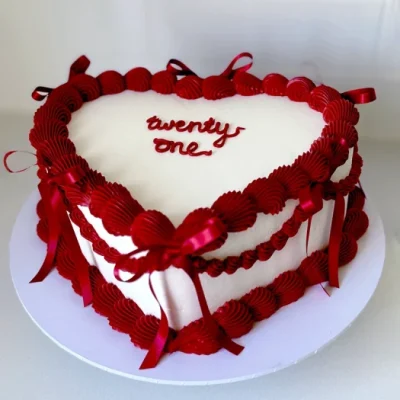 Heart shaped 21st birthday cake with the word Twenty One in the middle.